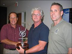 JAV, centre, receives the MCA trophy JAV, centre, receives the MCA trophy